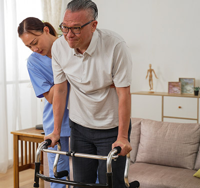Post-surgery care in Orlando, with a caregiver aiding a senior man's recovery at home.